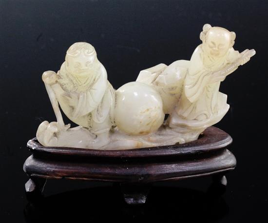 A Chinese pale celadon jade group of the immortals Li Tieguai and He Xiangu, 18th/19th century, 8cm, wood stand